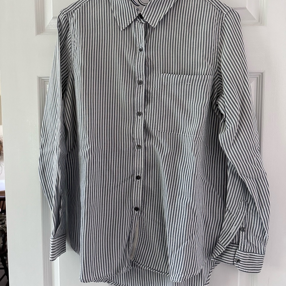 Women’s, button down grey and white striped blouse, with left breast pocket.